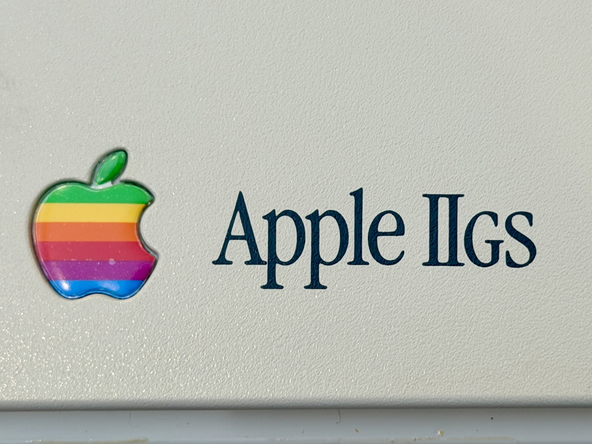 The Apple IIgs logo featuring the rainbow apple logo.